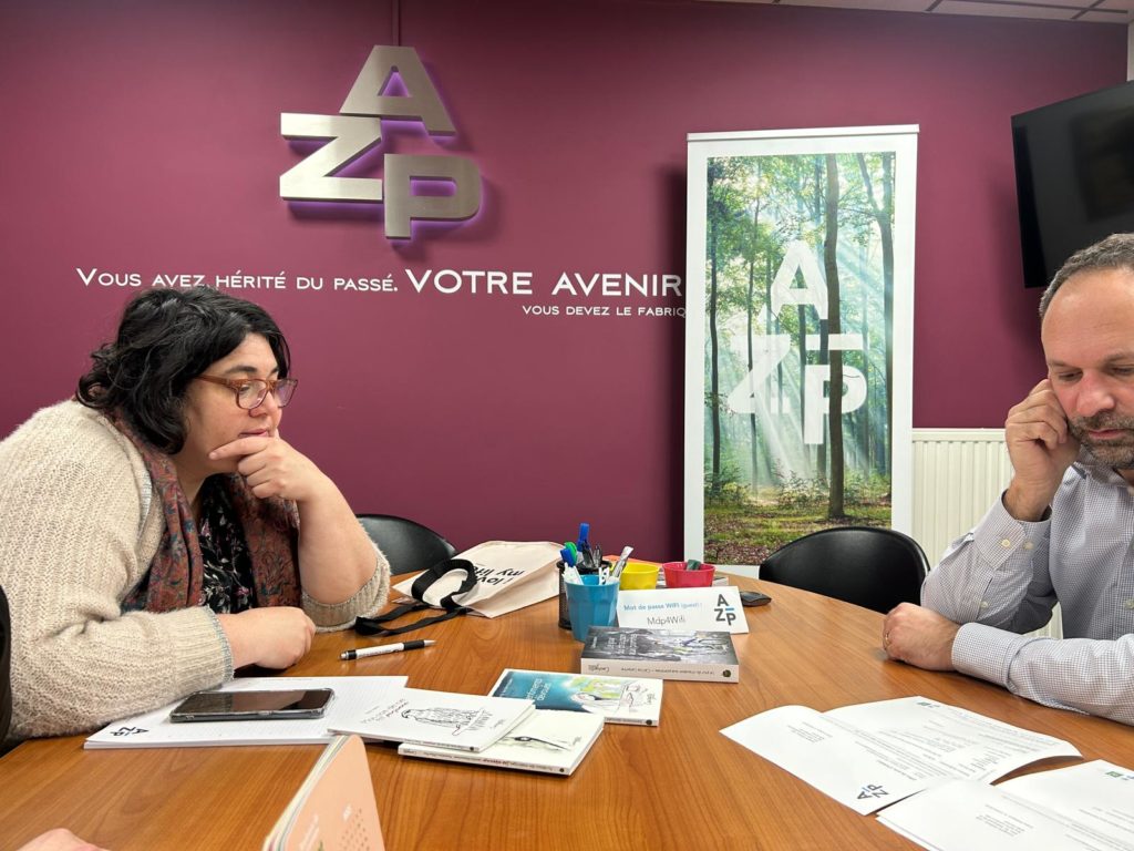 Réunion de travail entre Courgette Éditions et l’imprimeur AZ Print autour de livres et épreuves imprimées dans une salle de réunion.